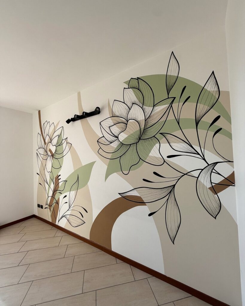 Large floral wall mural with green and tan organic shapes on a white interior wall.