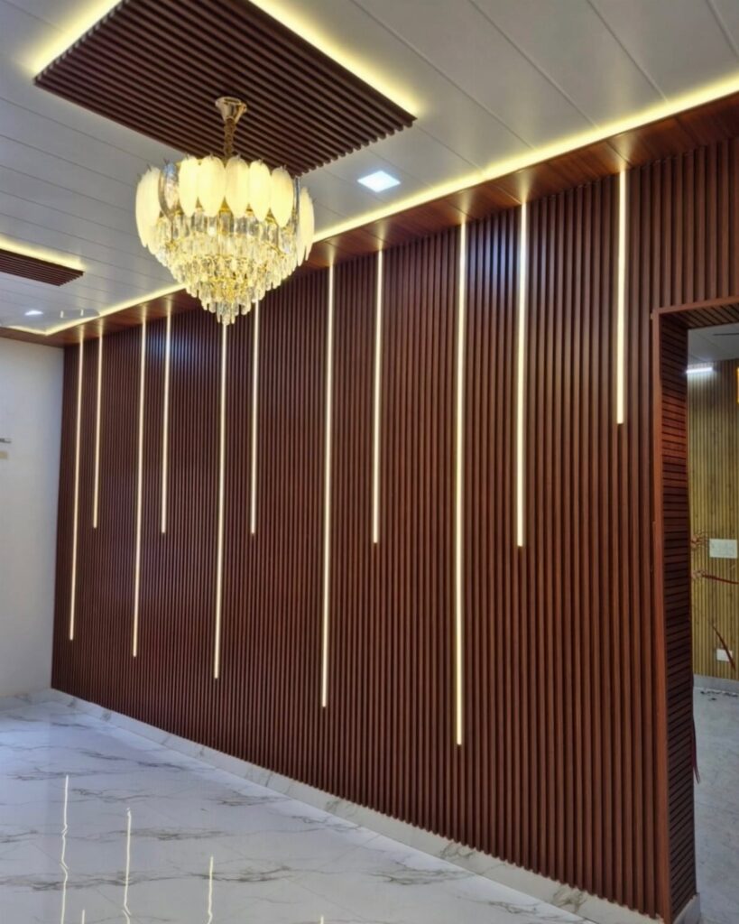 Dark wood fluted wall panels with vertical LED light strips and a crystal chandelier.
